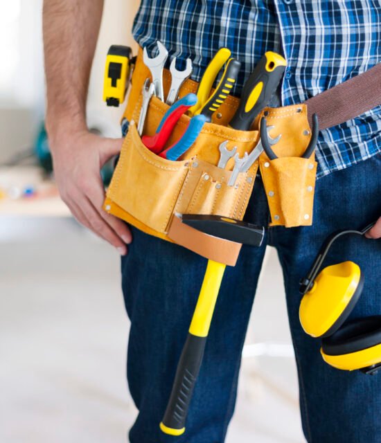 Part of construction worker with tools belt